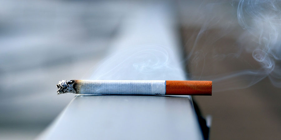 a white cigarette stick on top of a white surface
